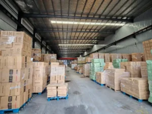 Aluminum foil rolls and foil containers in a factory warehouse ready for export